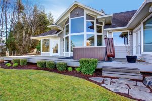 back deck of a home with hot tub